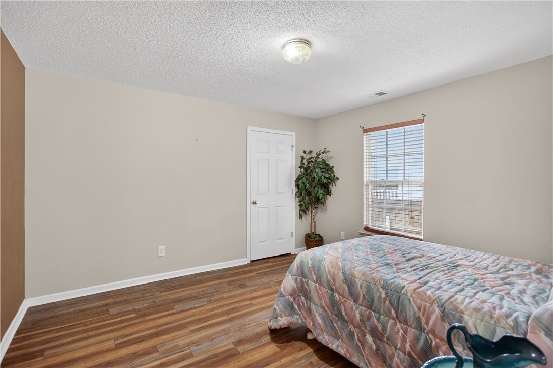 207 Hunters Lane Anderson, SC 29625 - Photo 27 of 46 Natural light filters through the window, illuminating rich hardwood flooring in this peaceful bedroom. All bedrooms have generous closet space.