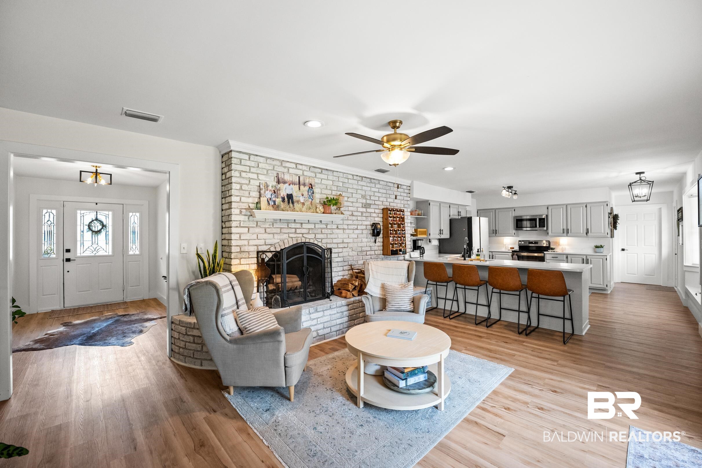 6 Wren Circle Foley, AL 36535 - Photo 15 of 55 Living area featuring visible vents, ceiling fan, a fireplace, and light wood-style floors