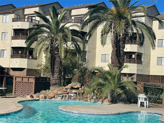 a view of a palm trees in front of a house