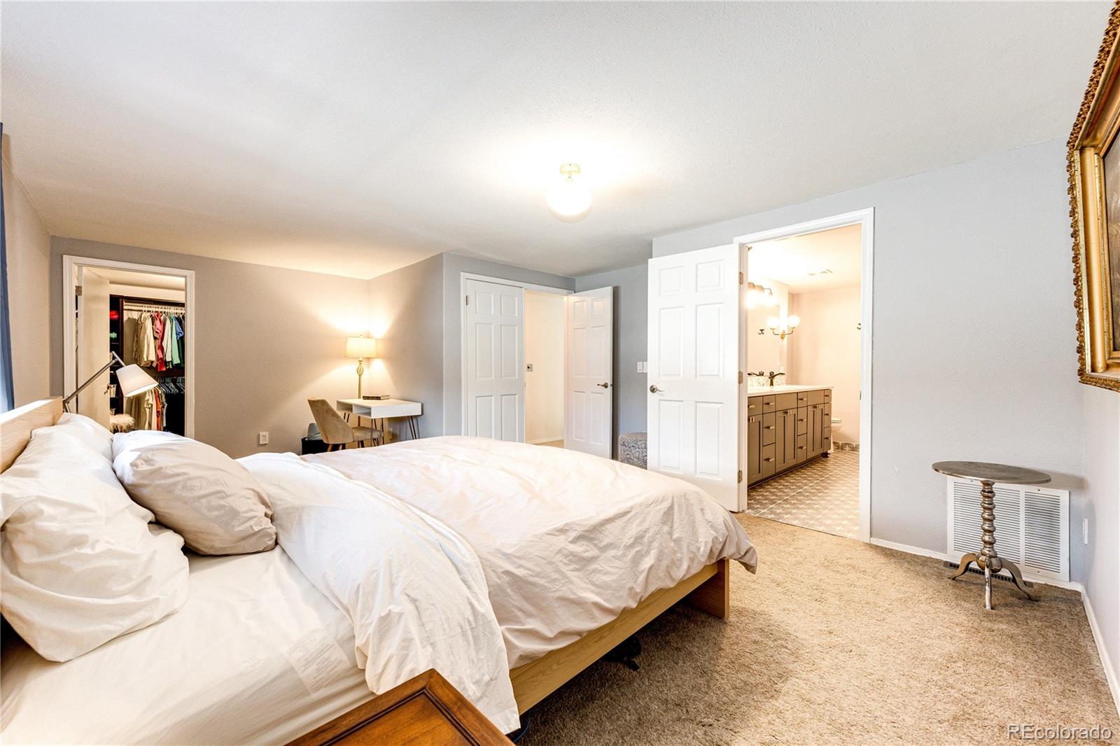 8712 Independence Way Arvada, CO 80005 - Photo 16 of 40 a spacious bedroom with a bed and a chair