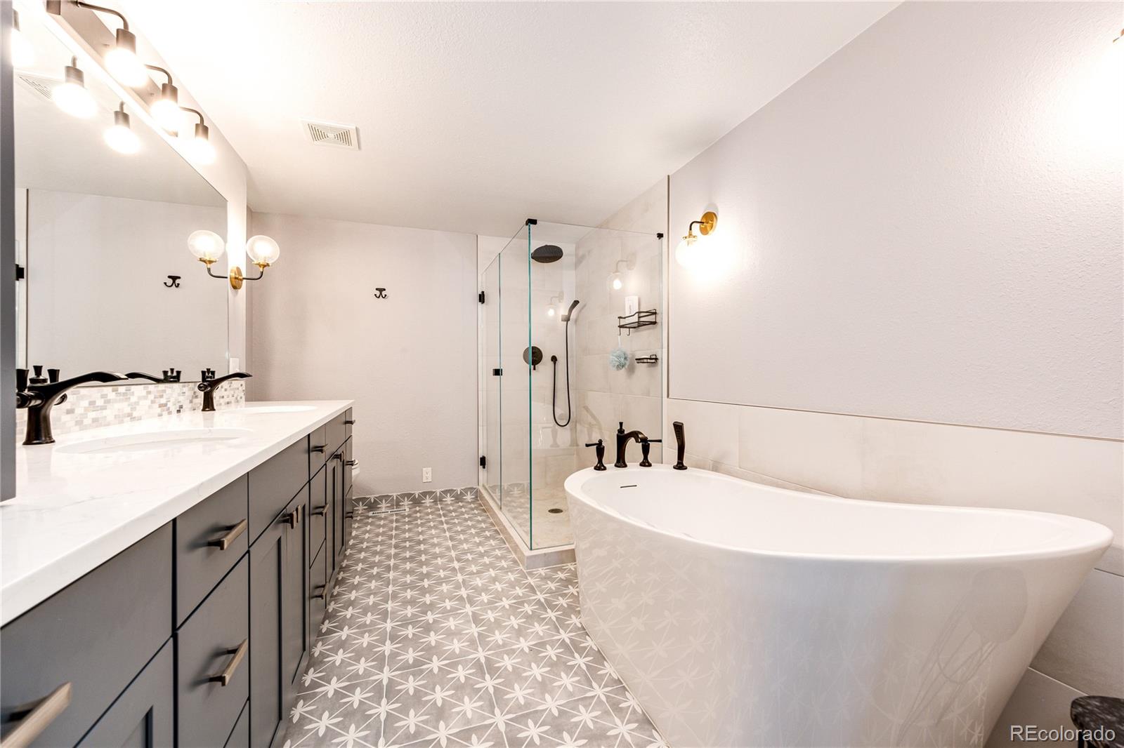 8712 Independence Way Arvada, CO 80005 - Photo 17 of 40 a bathroom with a bathtub and a sink