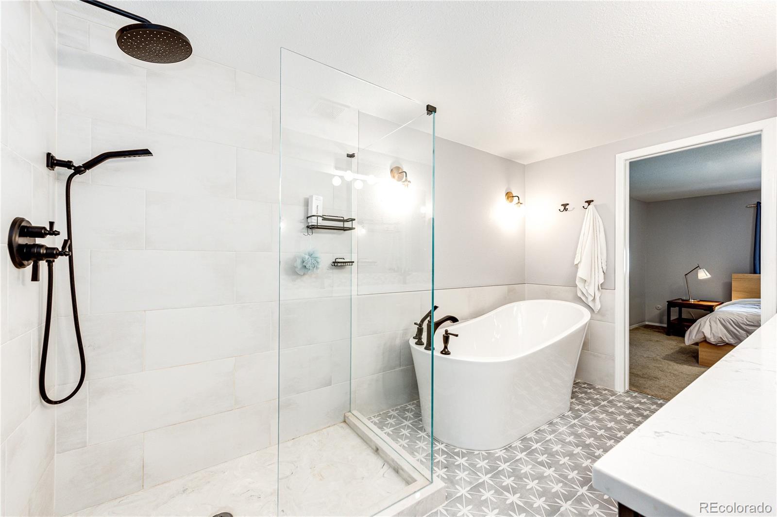 8712 Independence Way Arvada, CO 80005 - Photo 18 of 40 a spacious bathroom with a bathtub and shower