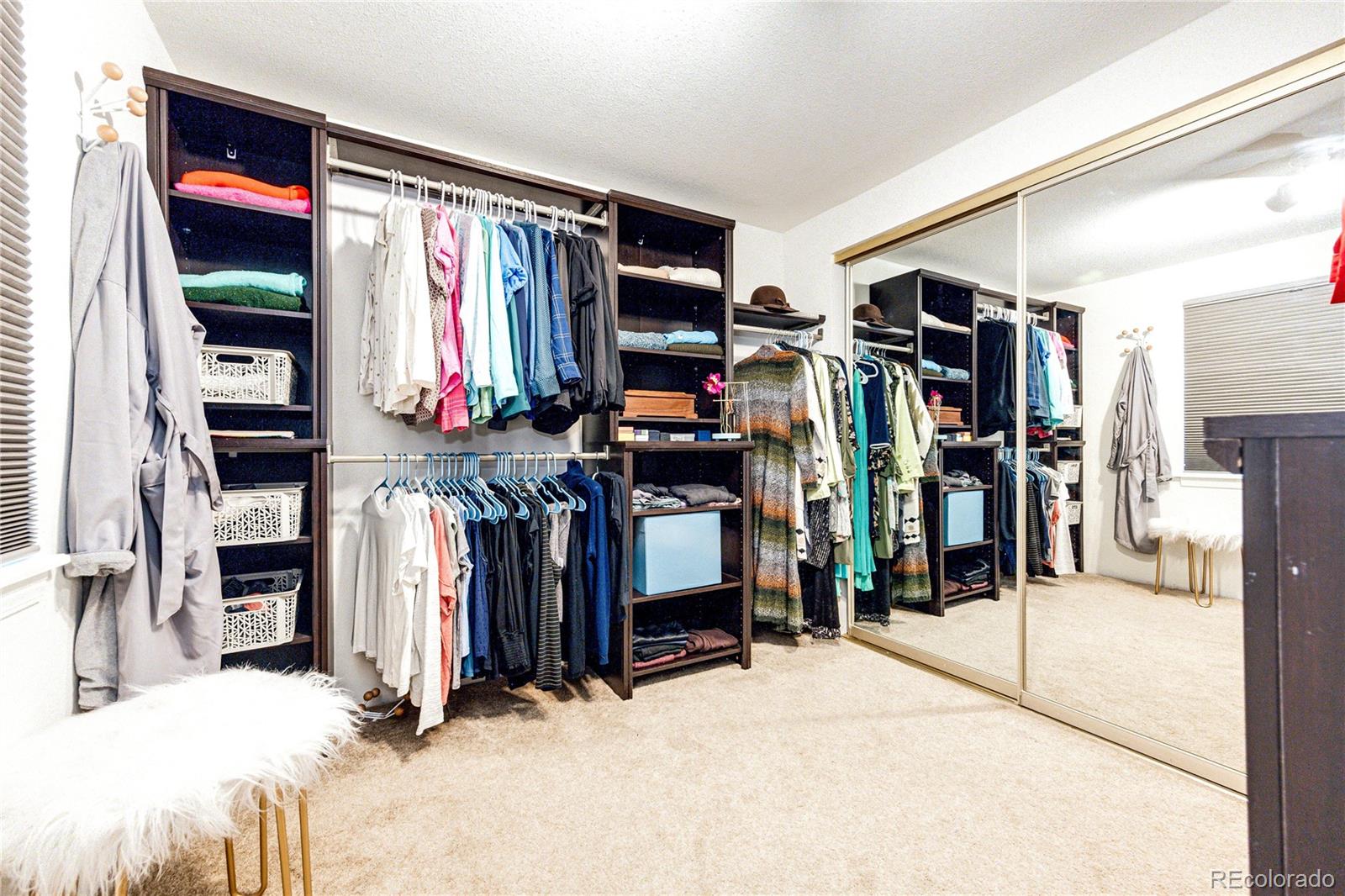 8712 Independence Way Arvada, CO 80005 - Photo 19 of 40 a view of walk in closet with clothes and shoes