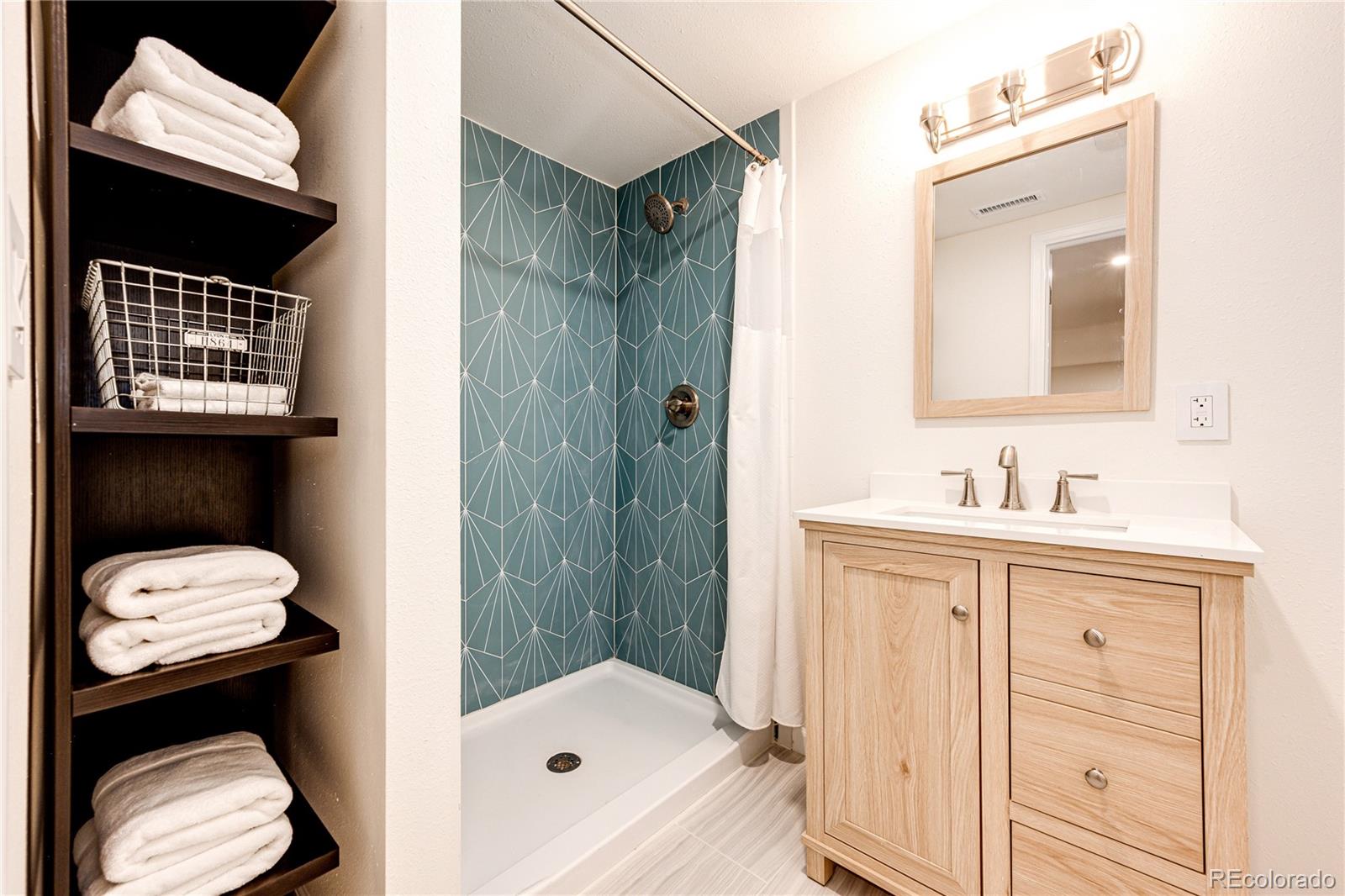 8712 Independence Way Arvada, CO 80005 - Photo 23 of 40 a bathroom with a sink a toilet and shower