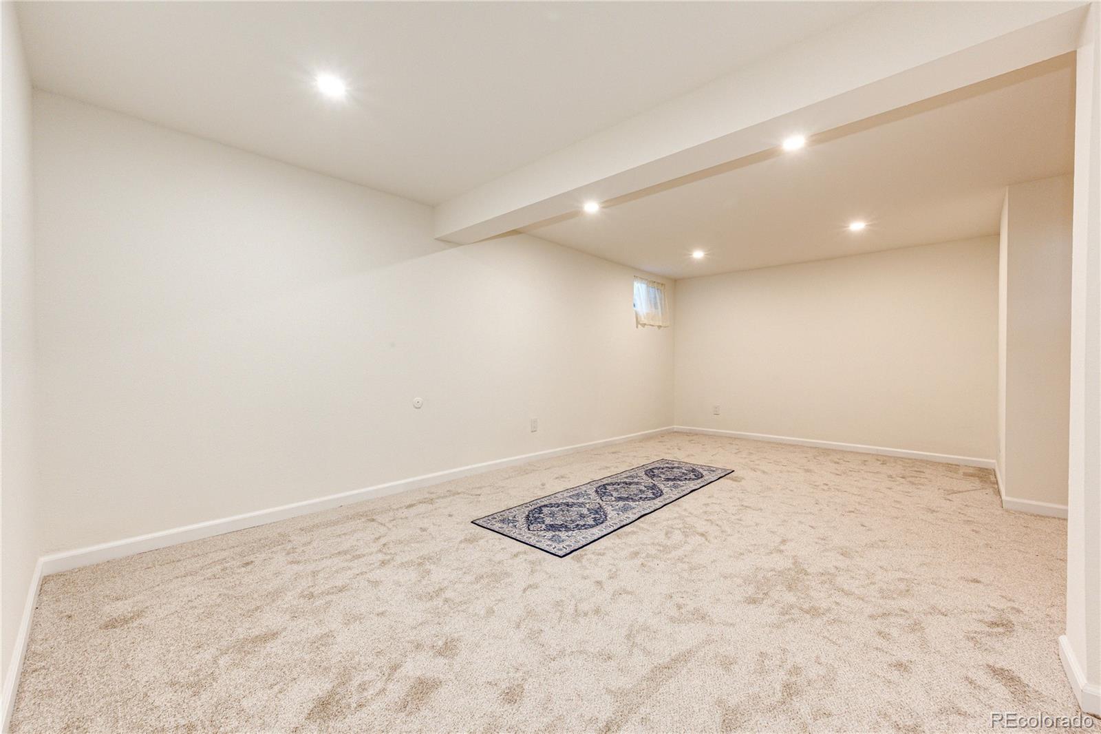 8712 Independence Way Arvada, CO 80005 - Photo 25 of 40 an empty room with a stove and a refrigerator