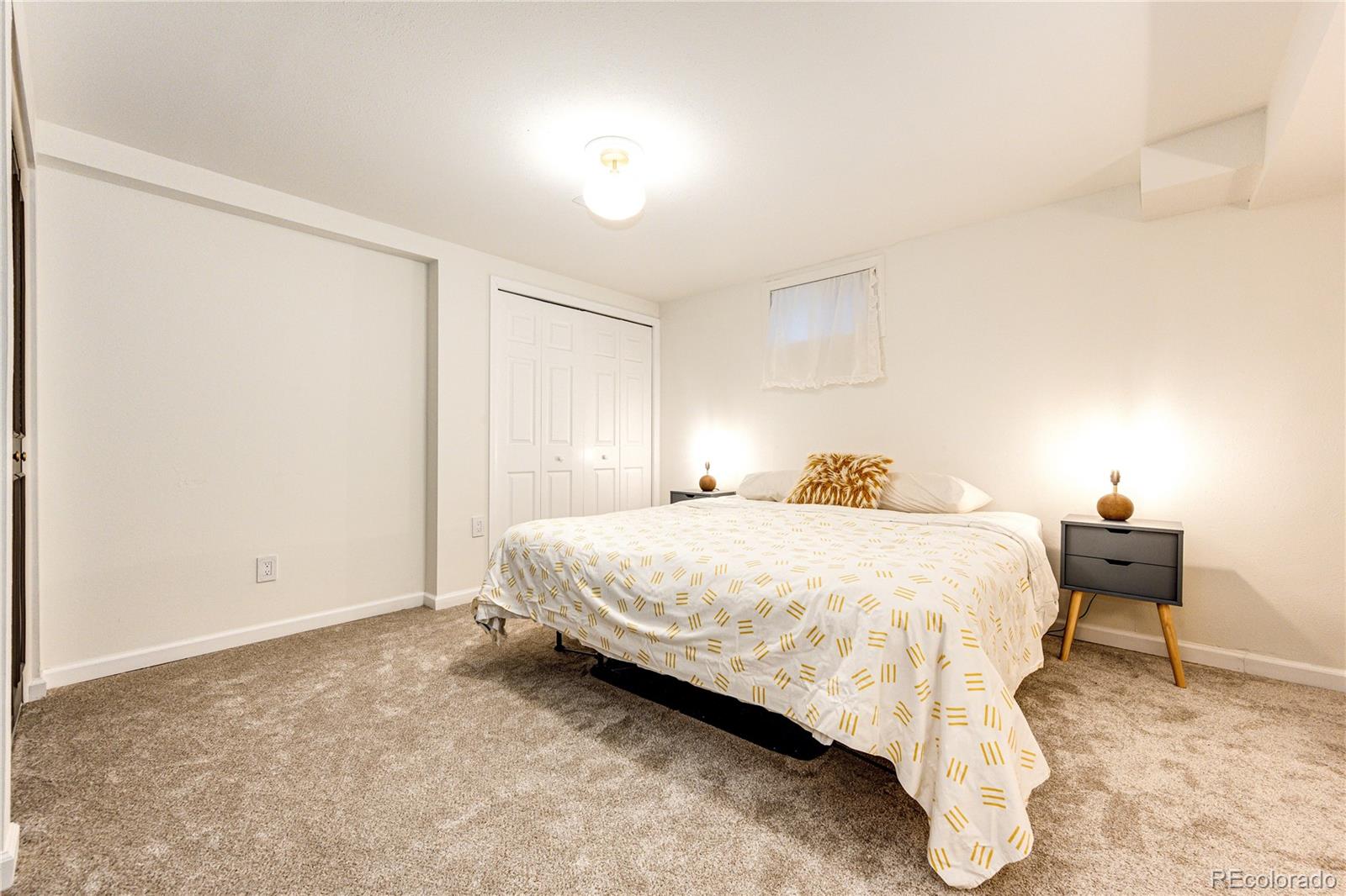 8712 Independence Way Arvada, CO 80005 - Photo 26 of 40 a bedroom with a bed and chair