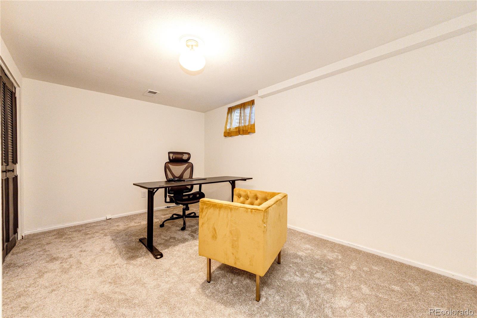 8712 Independence Way Arvada, CO 80005 - Photo 28 of 40 a room with a couch and a window