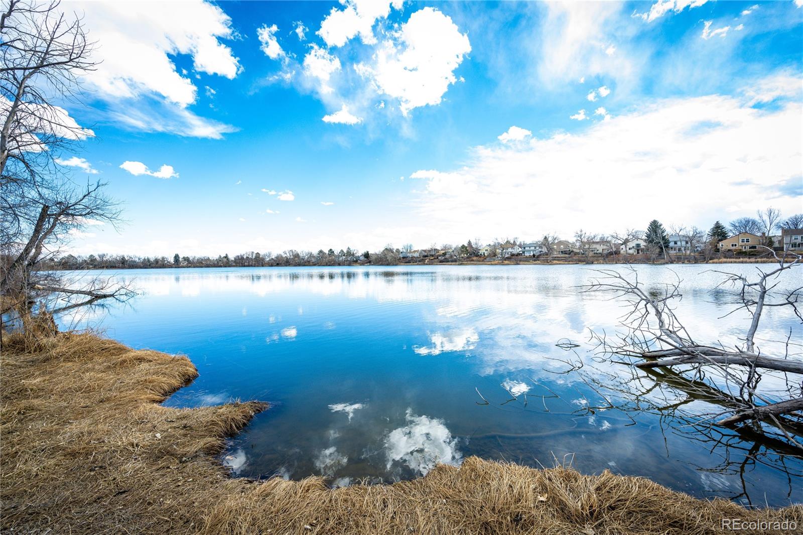 8712 Independence Way Arvada, CO 80005 - Photo 37 of 40 a view of a lake with lawn chairs
