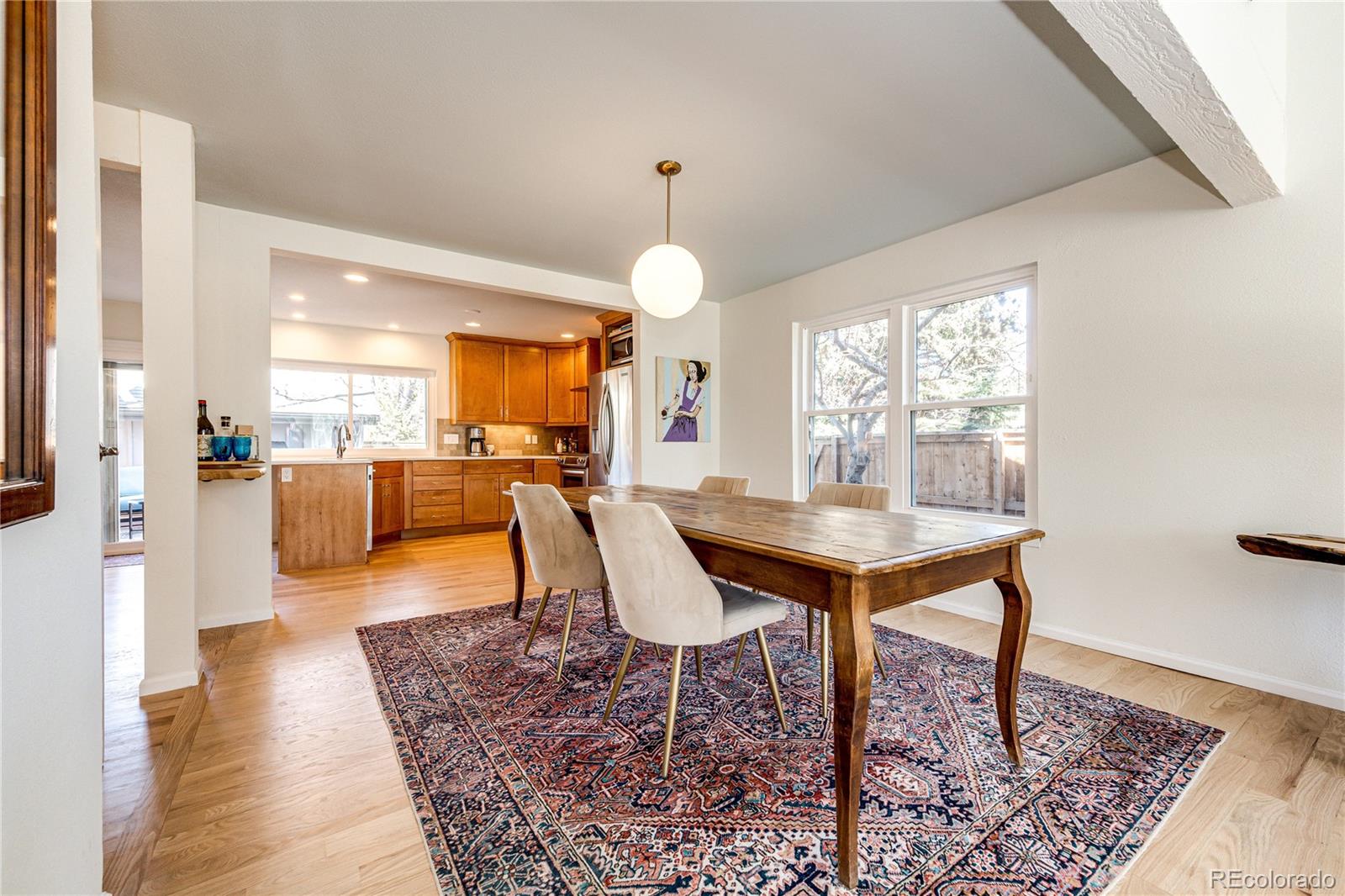 8712 Independence Way Arvada, CO 80005 - Photo 6 of 40 a view of a dining room with furniture and wooden floor