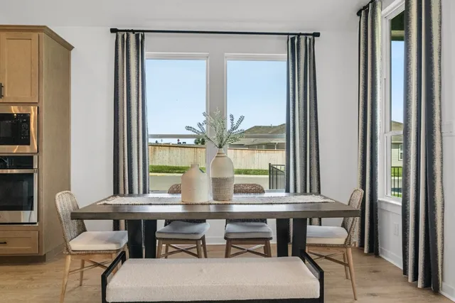 a view of a dining room with furniture and window