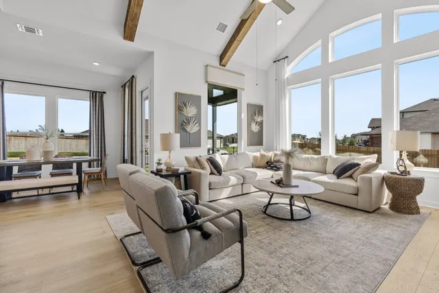 a living room with furniture and large windows