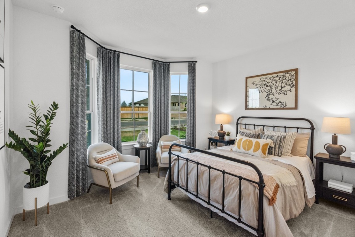 1300 Snowdrop Drive Georgetown, TX 78628 - Photo 4 of 28 a bed sitting in a bedroom next to a window with potted plant