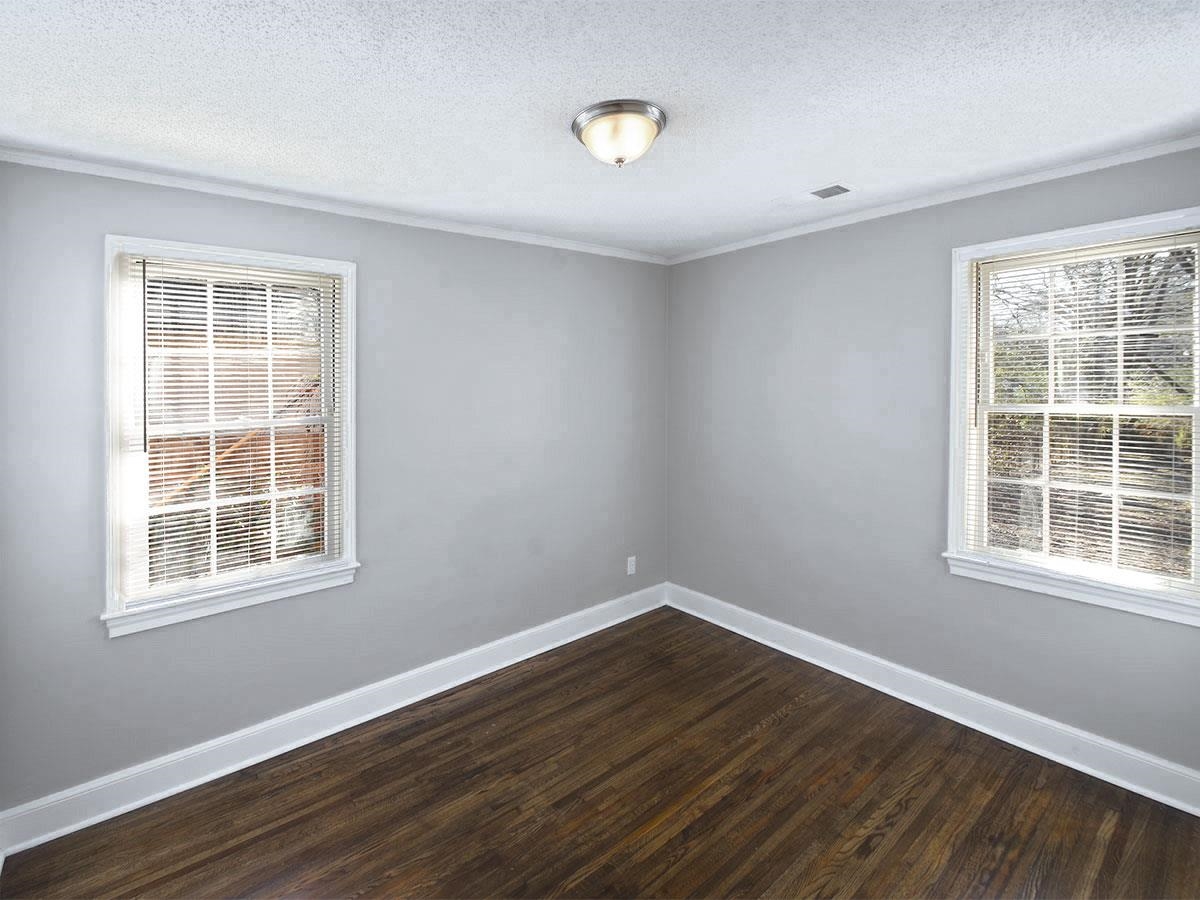 1019 Little John Road Memphis, TN 38111 - Photo 11 of 13 Unfurnished room with a textured ceiling and dark wood-type flooring