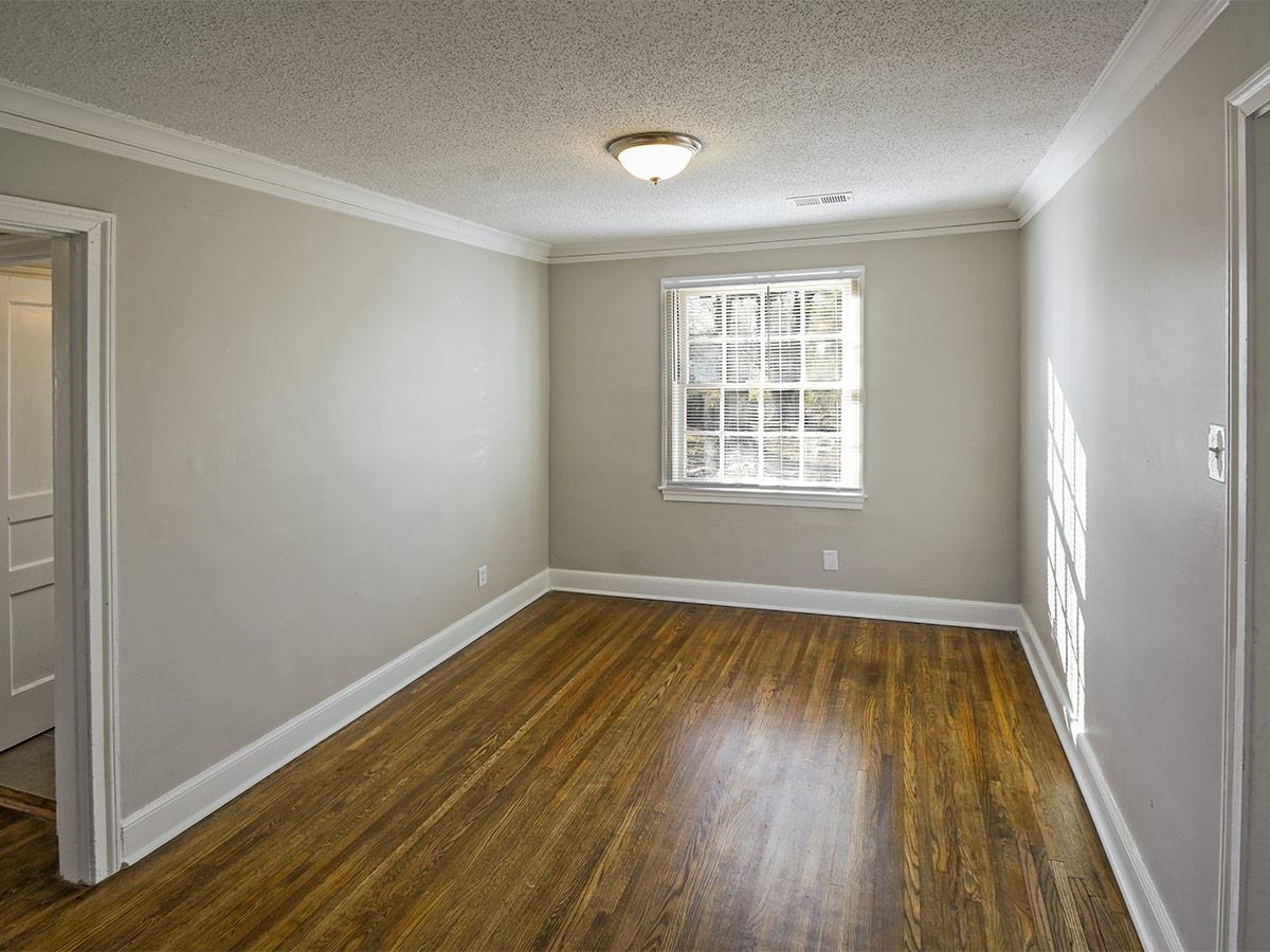 1019 Little John Road Memphis, TN 38111 - Photo 13 of 13 Spare room featuring a textured ceiling, crown molding, and dark hardwood / wood-style flooring