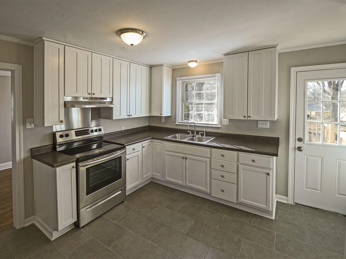 1019 Little John Road Memphis, TN 38111 - Photo 2 of 13 Kitchen featuring stainless steel range with electric stovetop, plenty of natural light, sink, and white cabinetry