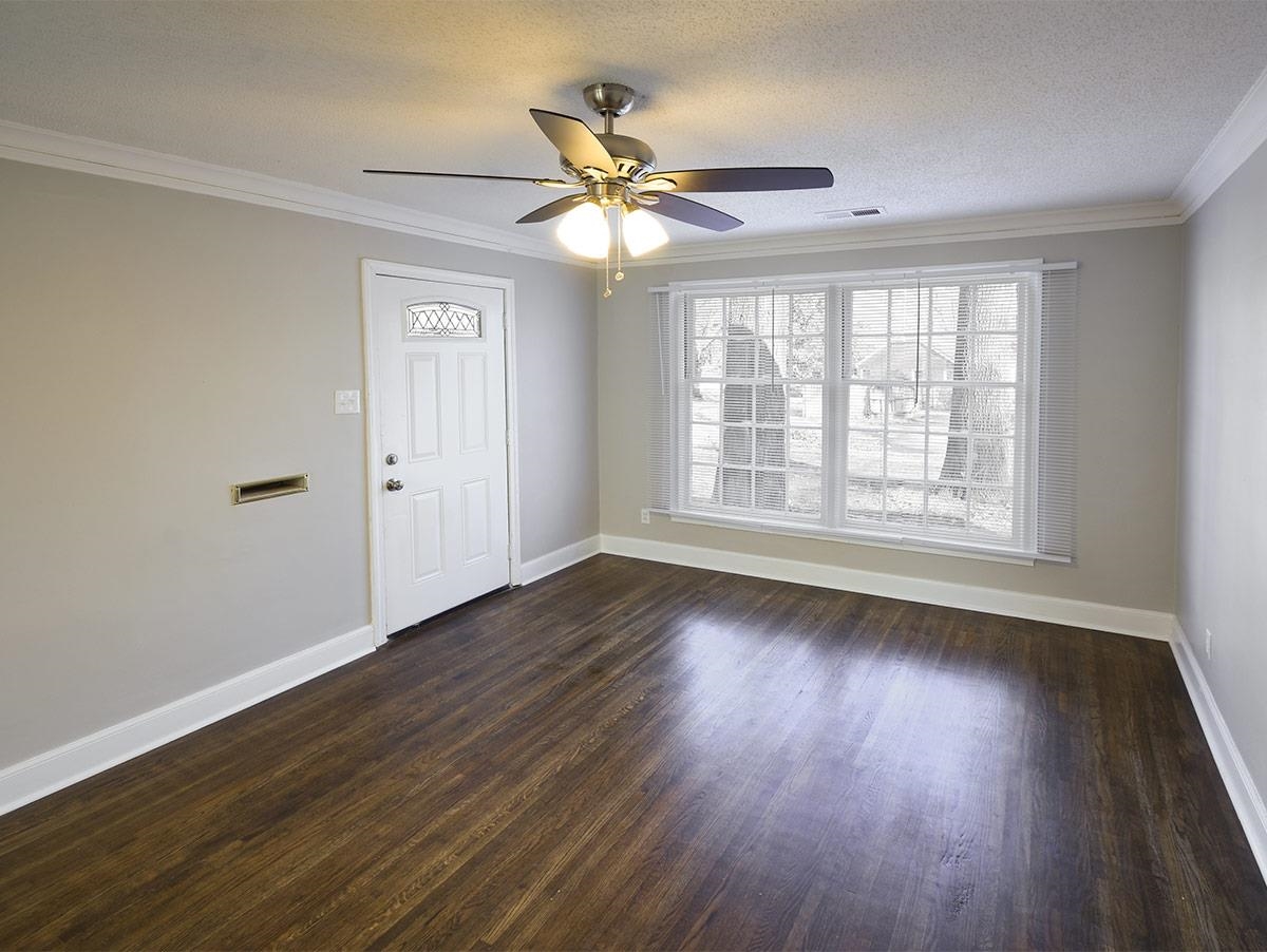 1019 Little John Road Memphis, TN 38111 - Photo 5 of 13 Unfurnished room with a textured ceiling, ceiling fan, dark hardwood / wood-style floors, and crown molding