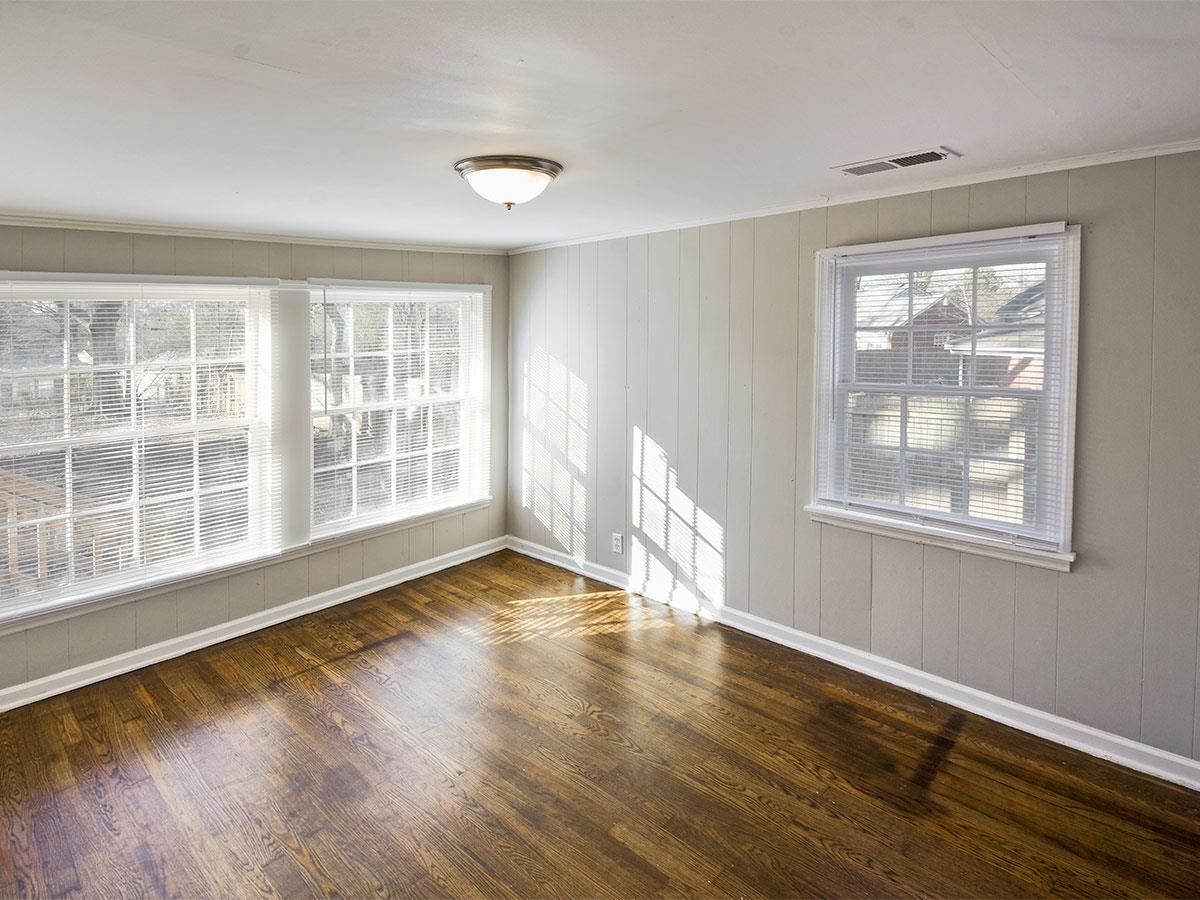1019 Little John Road Memphis, TN 38111 - Photo 10 of 13 Empty room featuring wooden walls and dark hardwood / wood-style floors