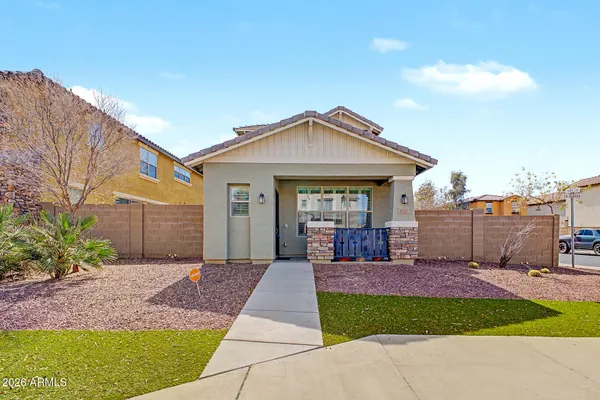 a front view of a house with a yard and outdoor seating