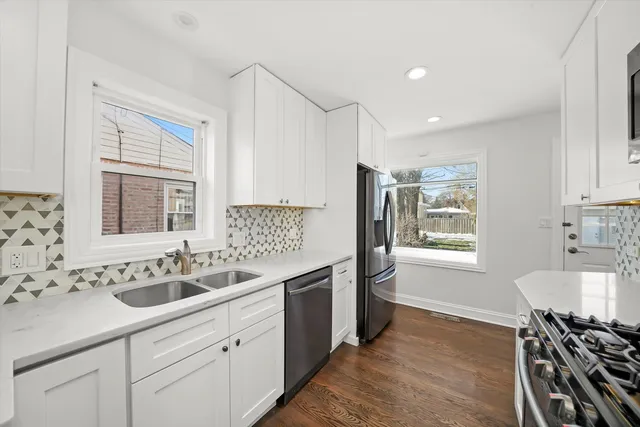 a kitchen with a sink stove and cabinets