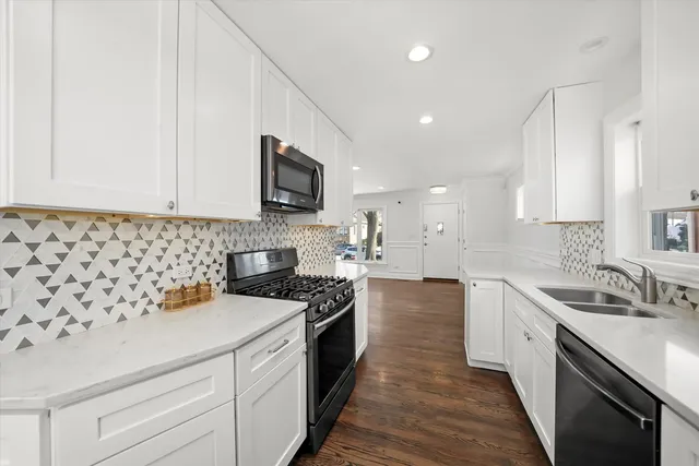 a kitchen with a sink stove and microwave