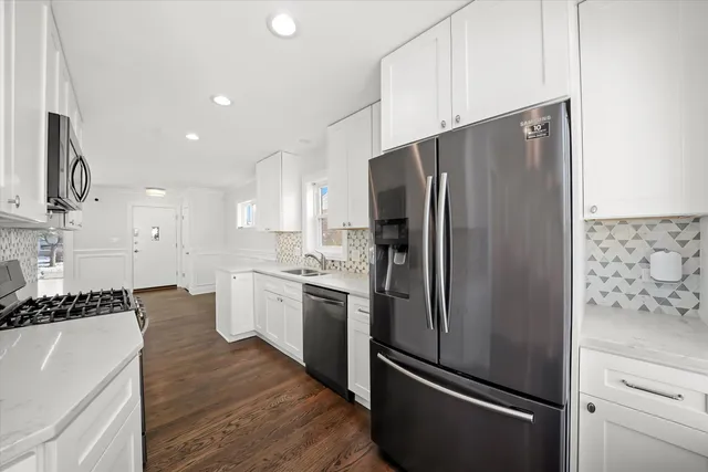 a kitchen with stainless steel appliances a refrigerator and a stove top oven
