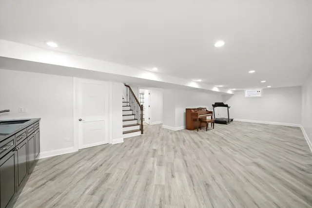 a view of a livingroom with wooden floor and staircase