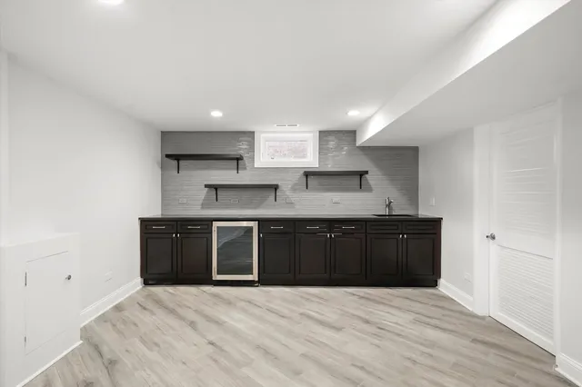 a large kitchen with granite countertop a stove top oven a sink dishwasher and a refrigerator with wooden floor