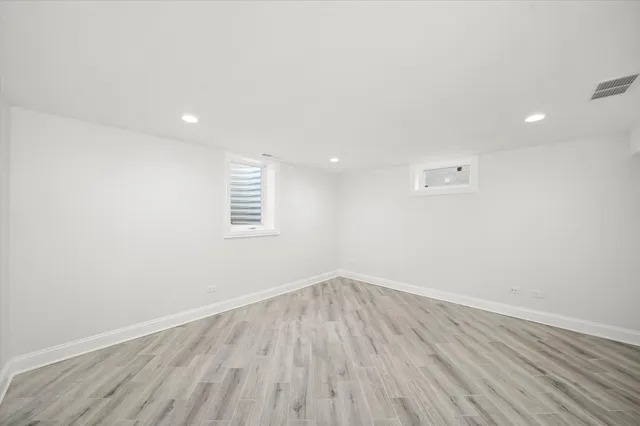 a view of room with wooden floor and window