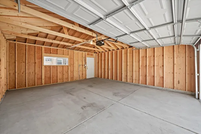 a view of a house with backyard and a tree