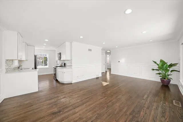 a view of kitchen with refrigerator and wooden floor