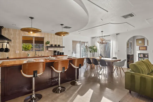 a living room with lots of furniture and a chandelier