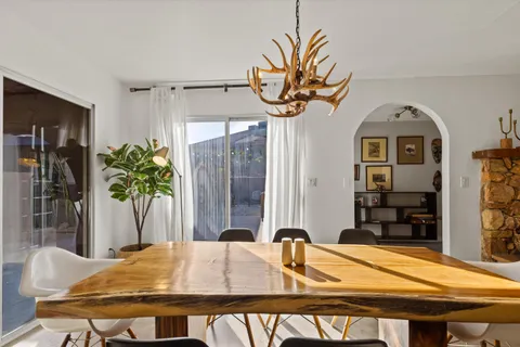 a dining room with furniture and window