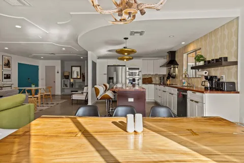 a living room with stainless steel appliances kitchen island granite countertop furniture and a kitchen view