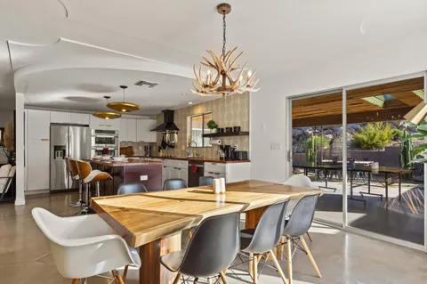 a view of a dining room with furniture window and outside view