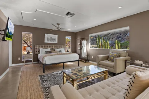 a bedroom with a bed a couch and dresser