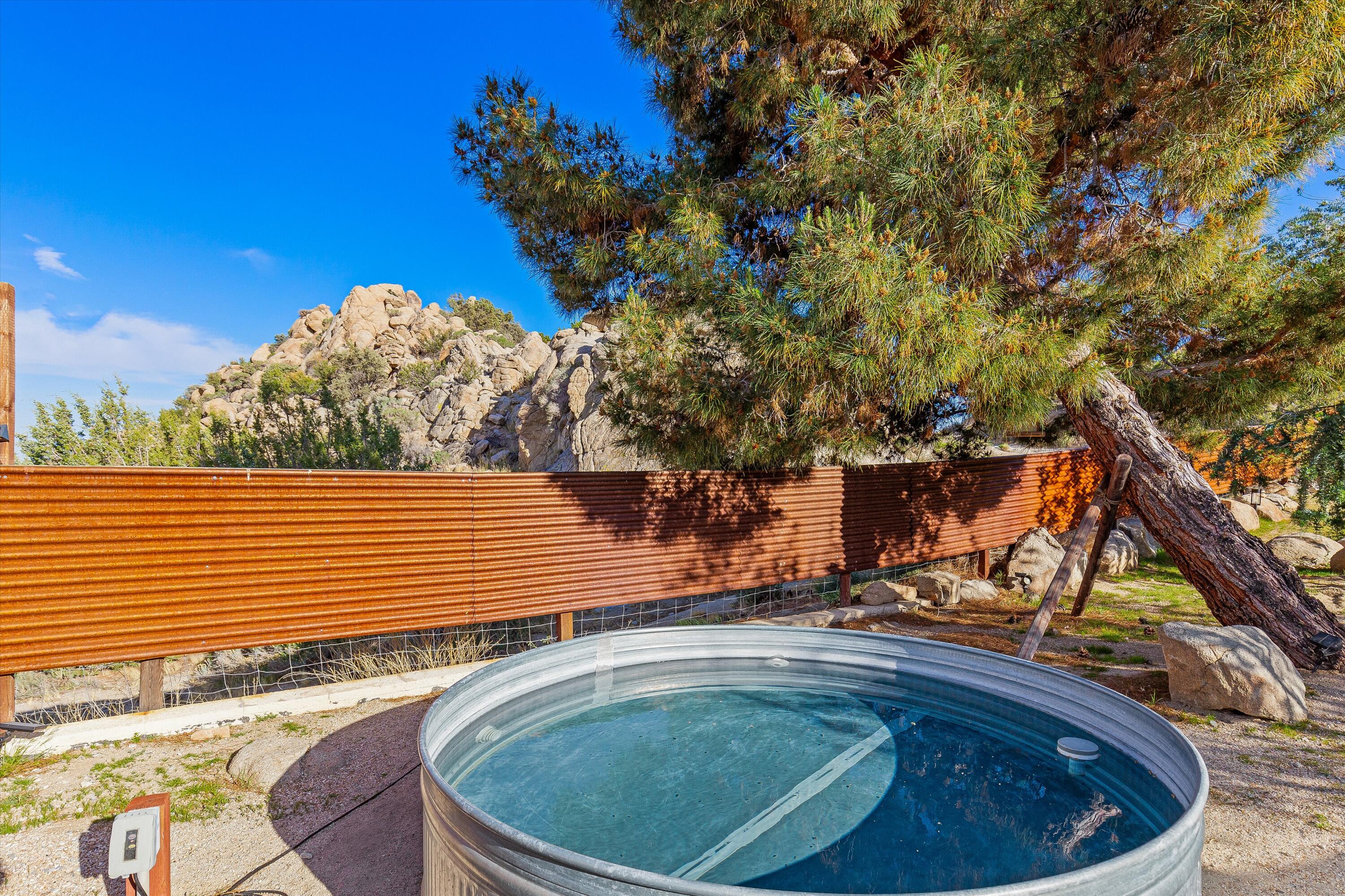 57113 Farrelo Road Yucca Valley, CA 92284 - Photo 30 of 46 a view of a swimming pool with a lounge chairs