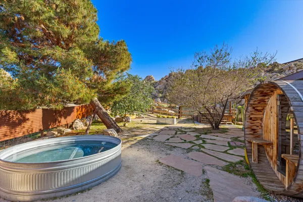 a backyard of a house with table and chairs