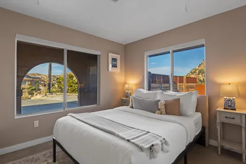 a bedroom with a bed and a painting on the wall