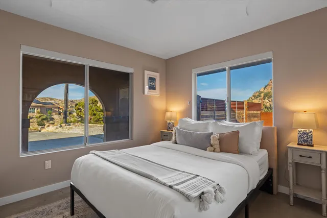 a bedroom with a bed and a painting on the wall