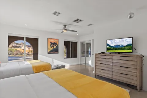 a bedroom with furniture and a flat screen tv