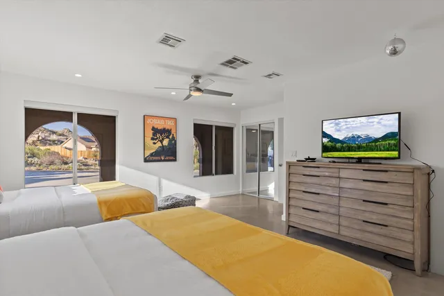 a bedroom with furniture and a flat screen tv