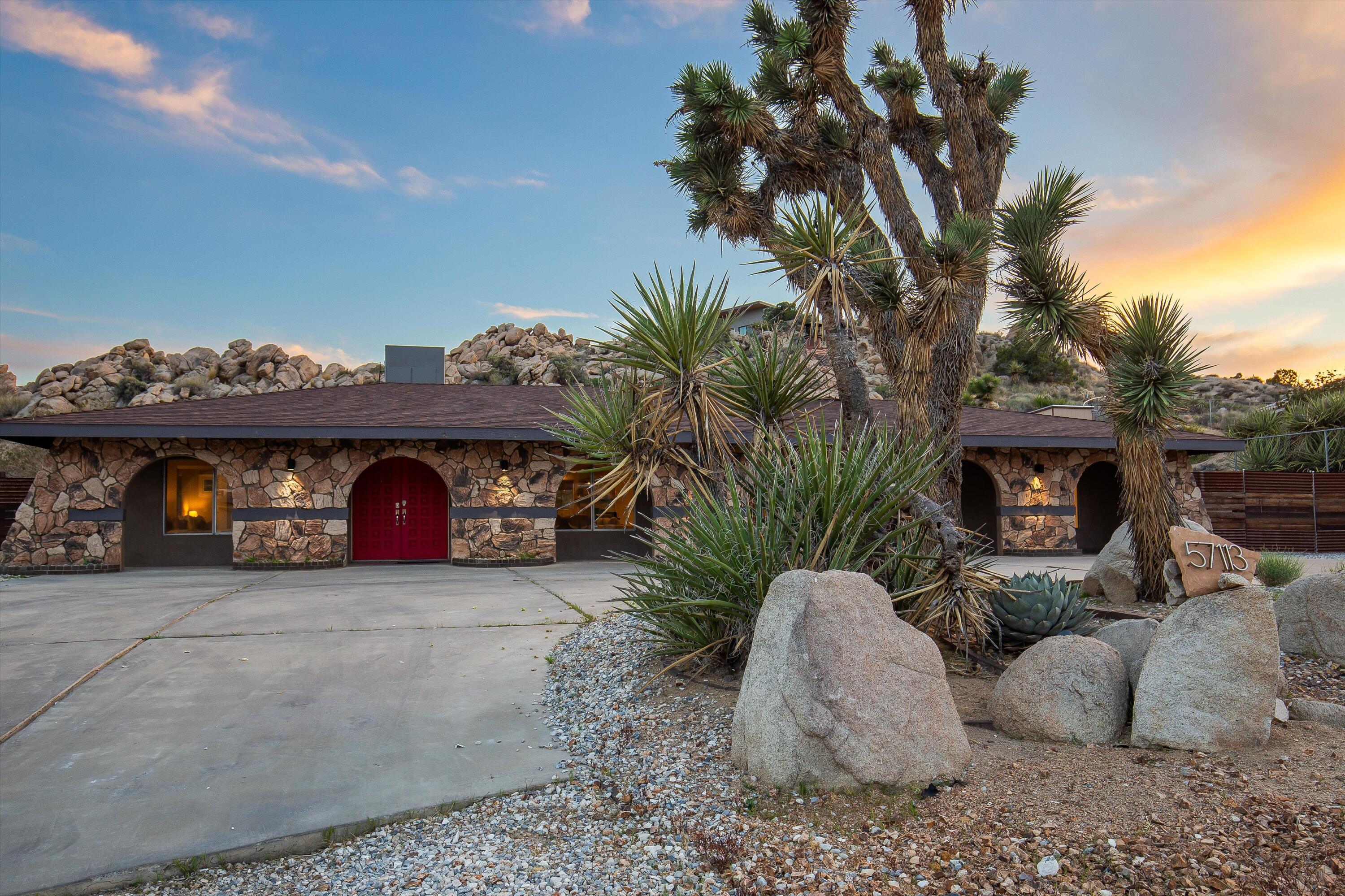 57113 Farrelo Road Yucca Valley, CA 92284 - Photo 38 of 46 a view of a couches and a fire pit in a yard