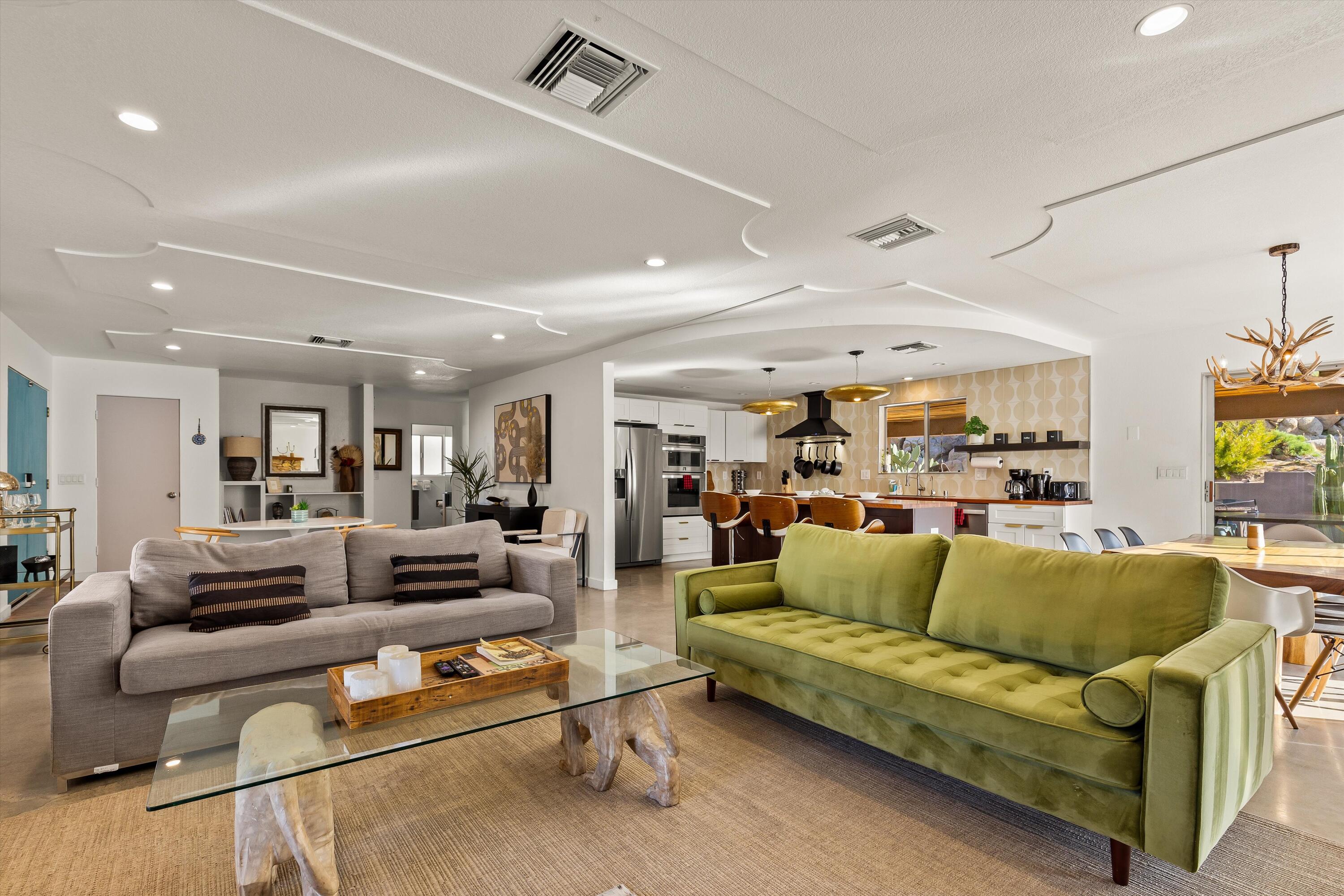 57113 Farrelo Road Yucca Valley, CA 92284 - Photo 8 of 46 a living room with furniture and a large window