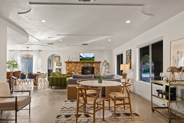 a living room with fireplace furniture and a flat screen tv