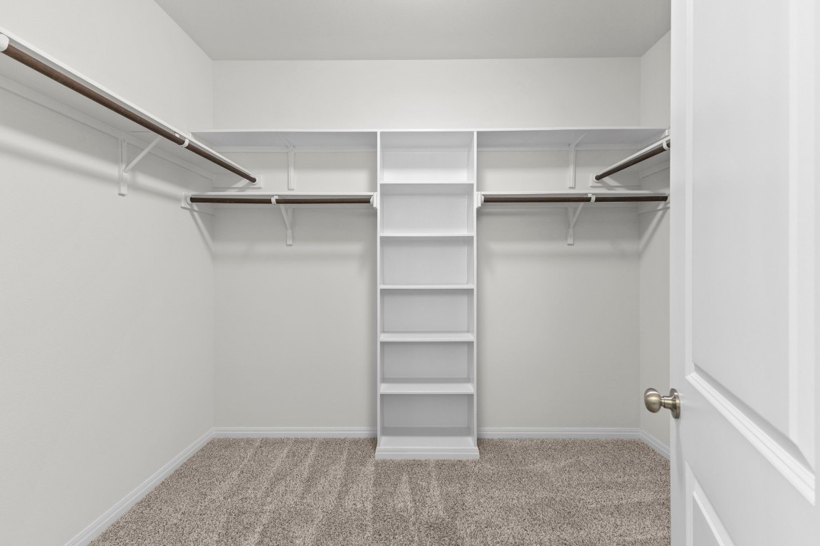 104 Scenic Hills Circle Georgetown, TX 78628 - Photo 23 of 30 a view of walk in closet with empty racks