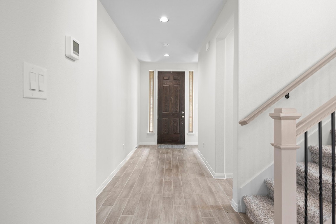 104 Scenic Hills Circle Georgetown, TX 78628 - Photo 7 of 30 a view of a hallway with wooden floor and entryway