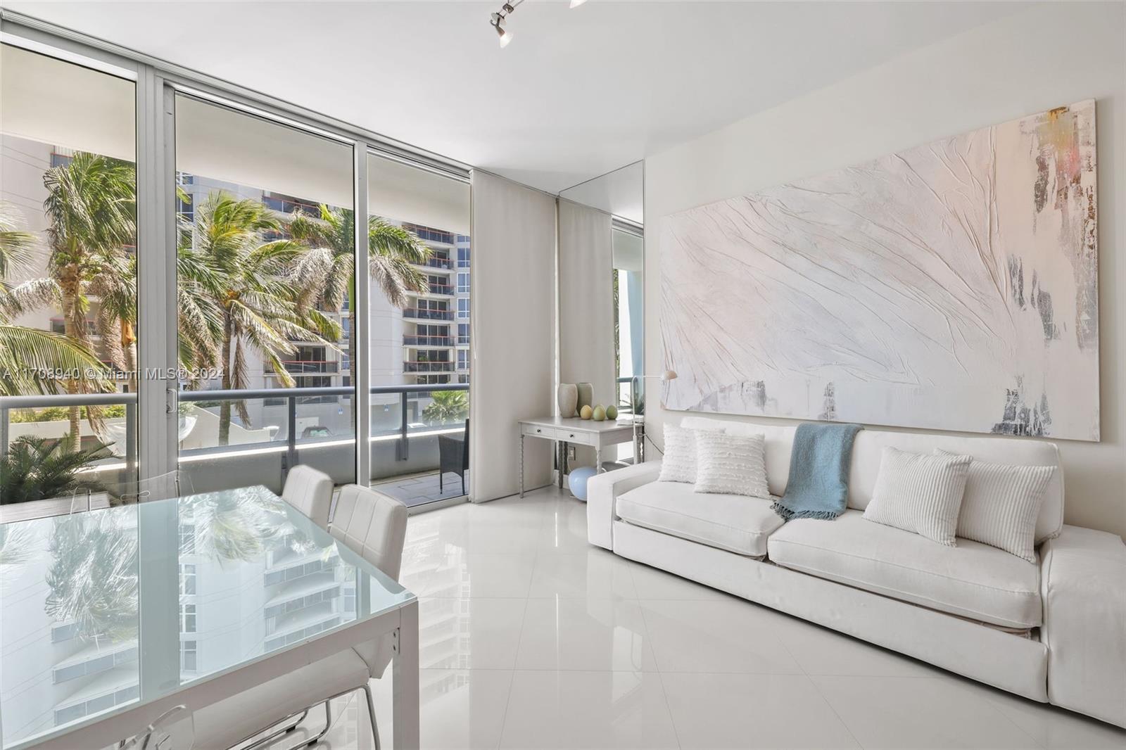 6799 Collins Avenue, Unit 207 Miami Beach, FL 33141 - Photo 11 of 35 a living room with furniture and a large window