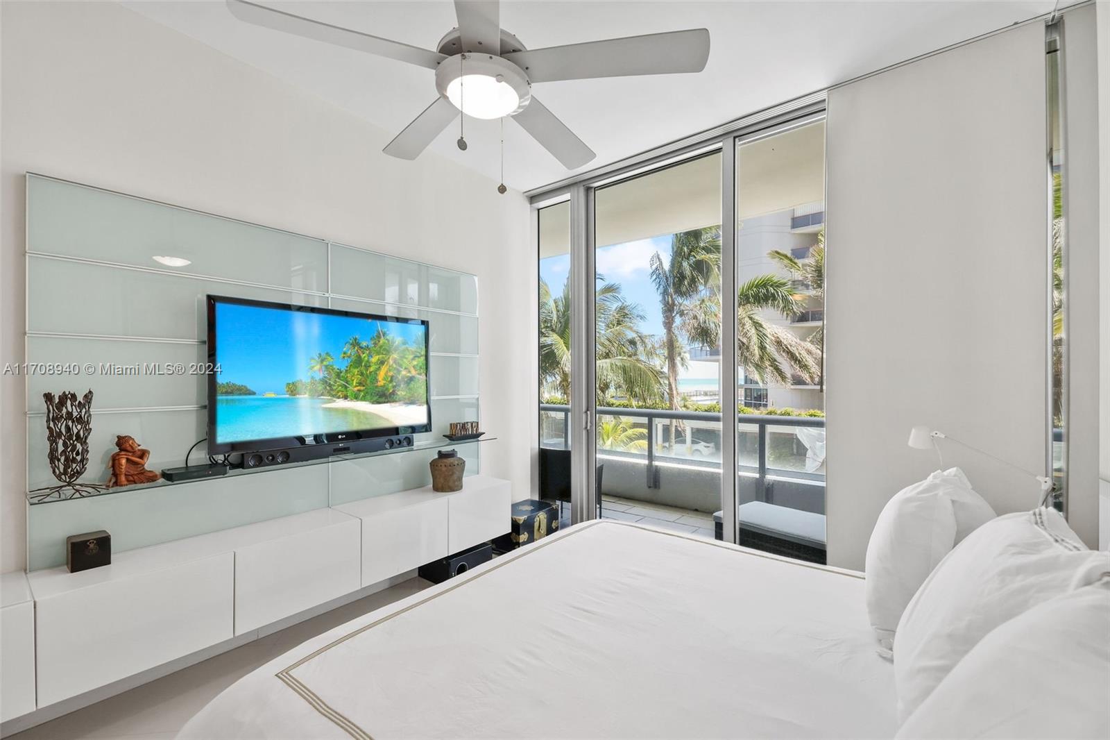 6799 Collins Avenue, Unit 207 Miami Beach, FL 33141 - Photo 12 of 35 a living room with furniture and a flat screen tv