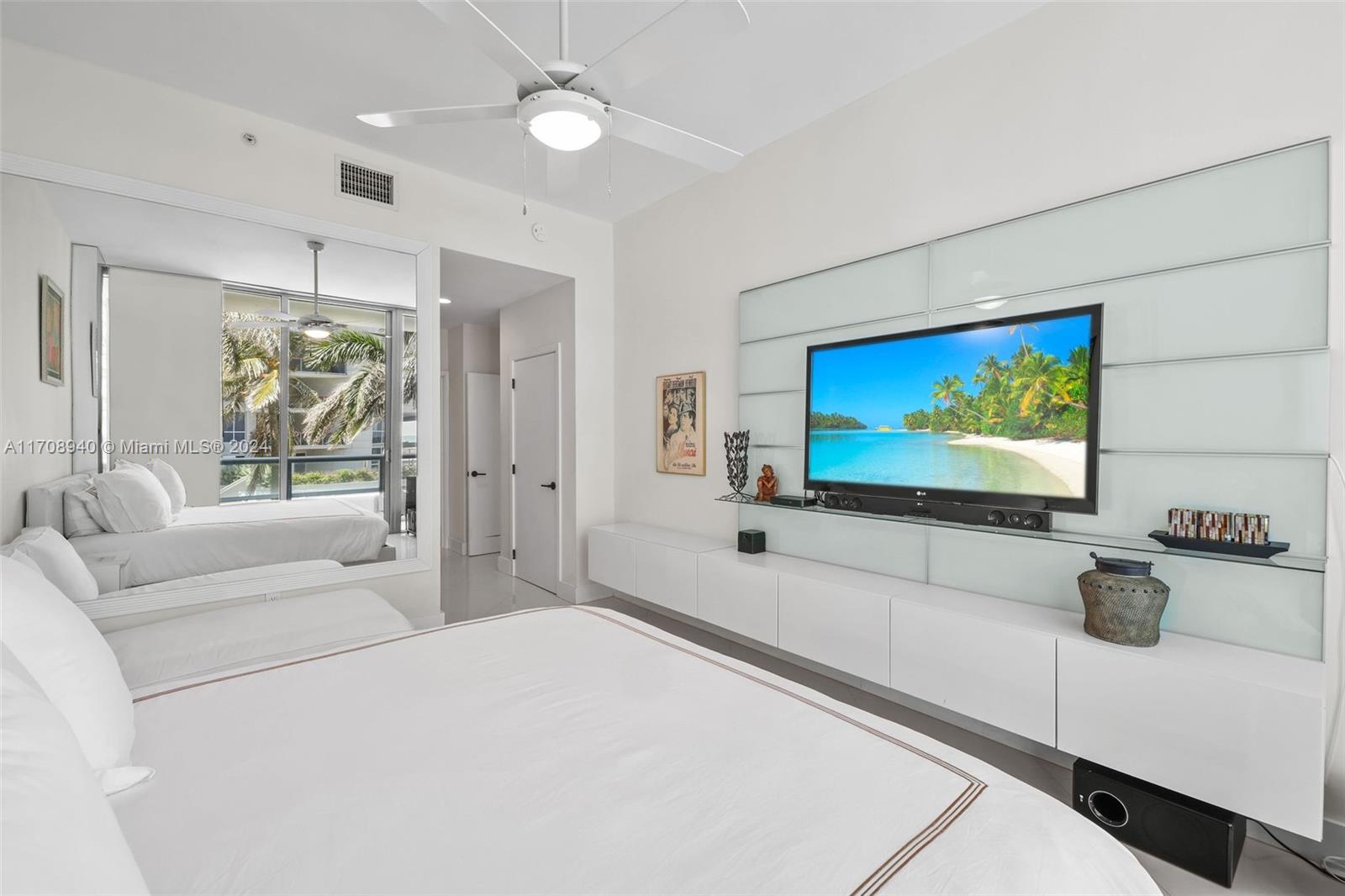 6799 Collins Avenue, Unit 207 Miami Beach, FL 33141 - Photo 14 of 35 a living room with furniture and a flat screen tv