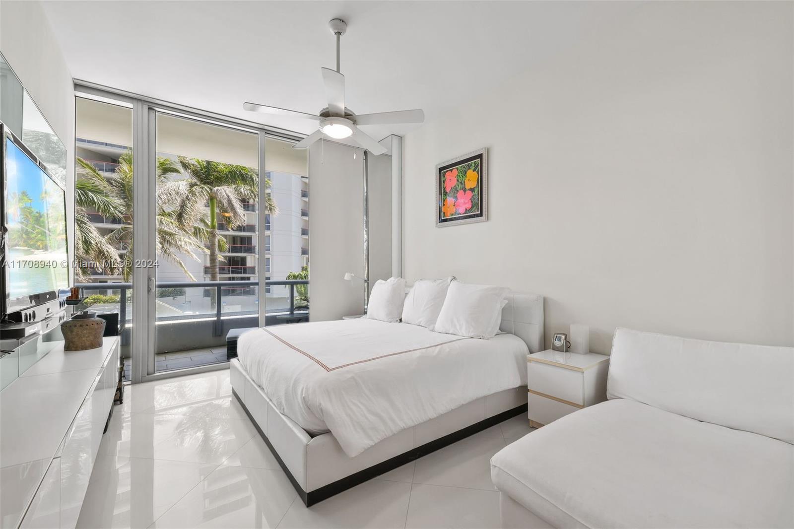 6799 Collins Avenue, Unit 207 Miami Beach, FL 33141 - Photo 15 of 35 a bedroom with a large bed and a large window